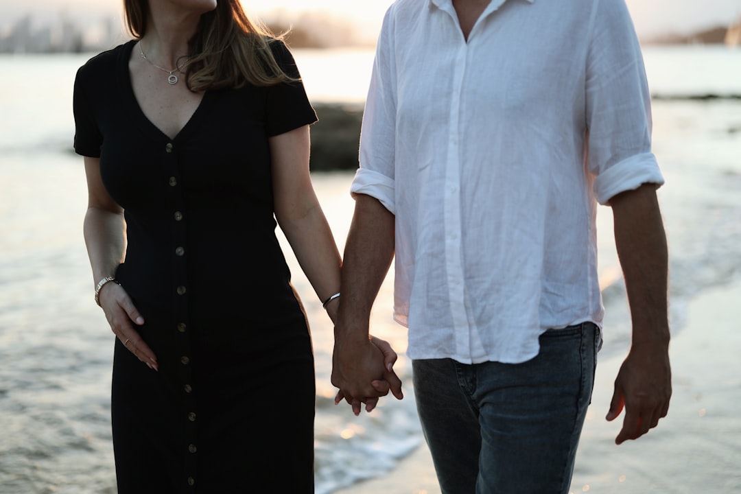 Couple holding hands looking at financial plan together peacefully