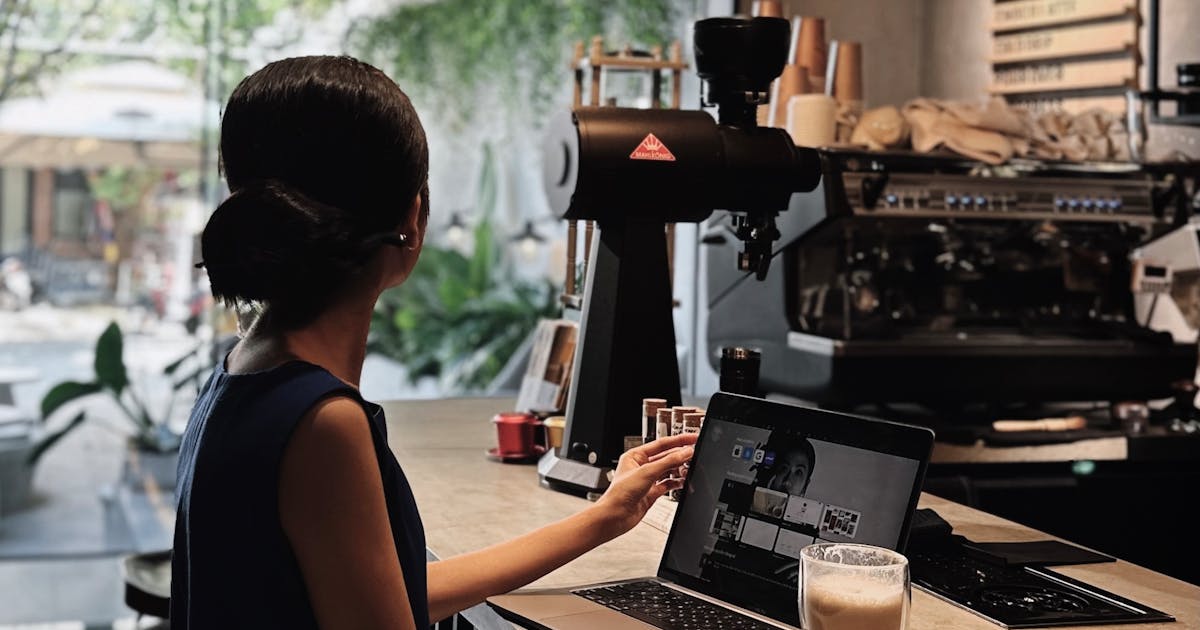Woman at a cafe with laptop and coffee