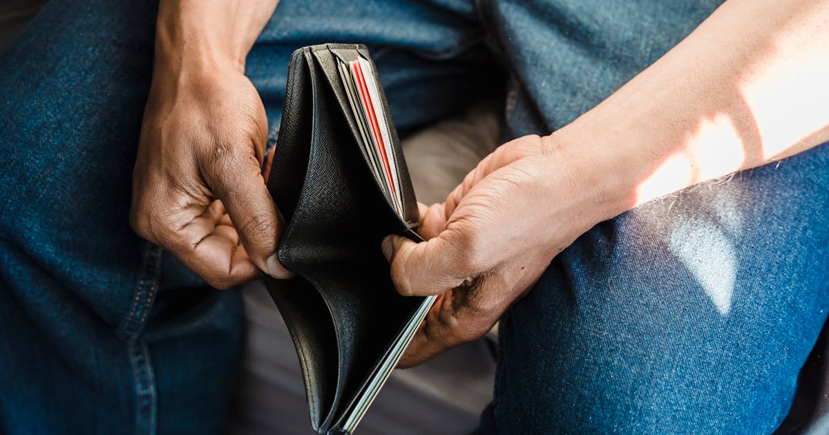 Person looking at an empty wallet
