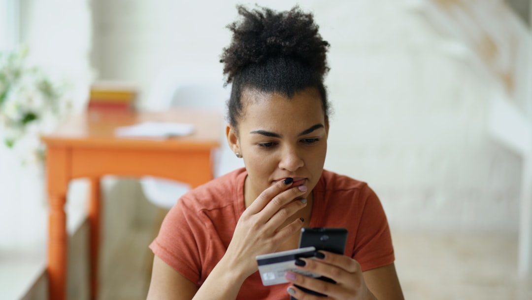 Woman shopping online with credit card and smartphone